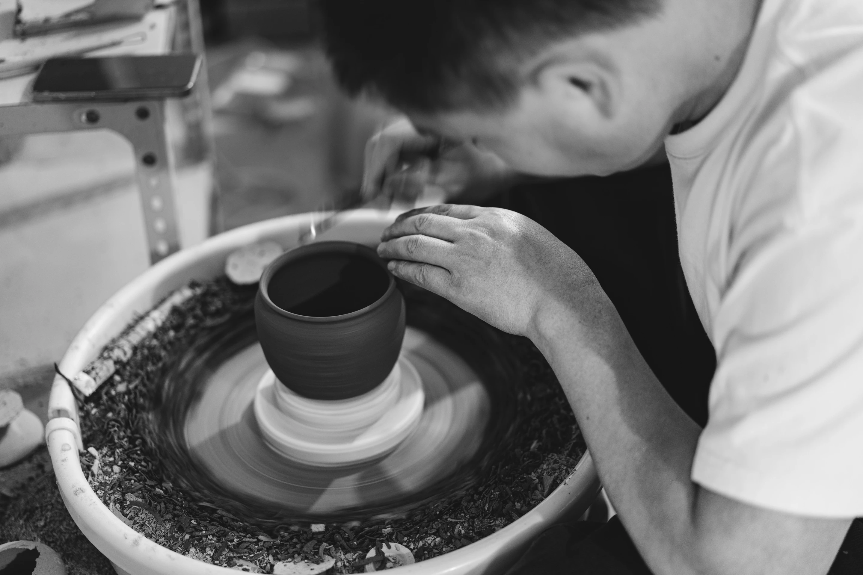 Pottery art- steady hands and spinning pot